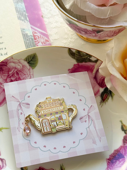 Wisteria Road Tea Society Pin Club April edition pin featuring a delicate floral design on a gold-tone backing.
